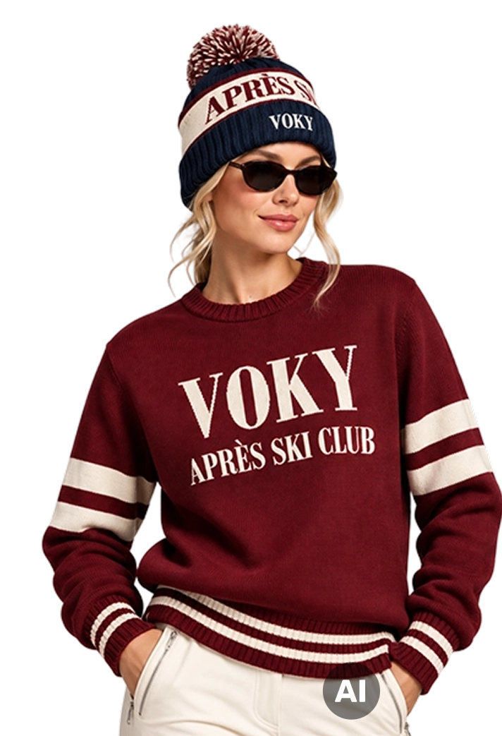 Kvinna i vinr&ouml;d Voky Apr&egrave;s Ski Club-stickad tr&ouml;ja och matchande pompomm&ouml;ssa.